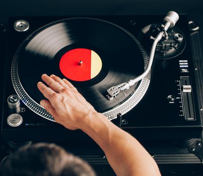 turntable scratch, hand of dj on the vinyl record