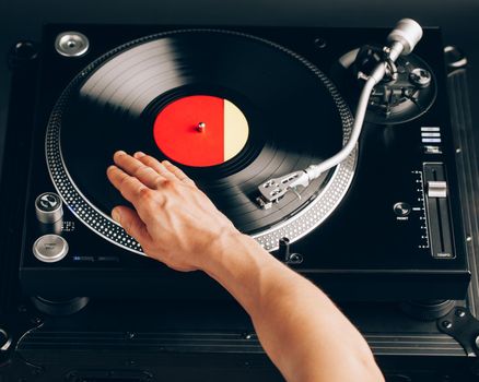 turntable scratch, hand of dj on the vinyl record