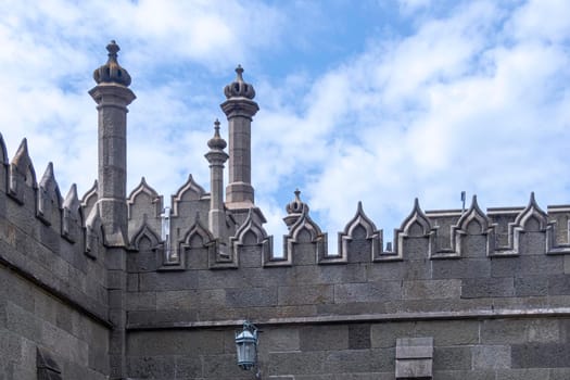 castle walls with towers against the blue sky. High quality photo