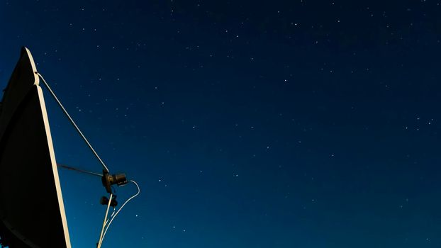 The night starry sky against of a satellite dish.Exploring the cosmos and the stars.Astrology,astrophotography and the study of galaxies in the sky.Movements of stars and planets at night.astrophoto