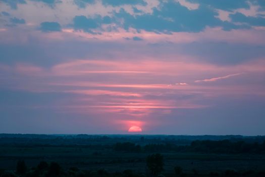 Sunset at the evening dawn.Morning dawn.Late evening.Evening sunset.The last rays of the sun in the evening hours and the onset of night.The first rays of the sun pass through the clouds.Glow pink sky