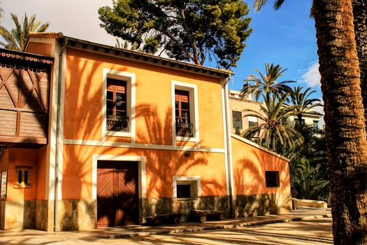 Elche, Spain- 14 February, 2018: Typical and colorful house in a palm orchard in Elche, Spain on a sunny day. Huerto de San Placido.