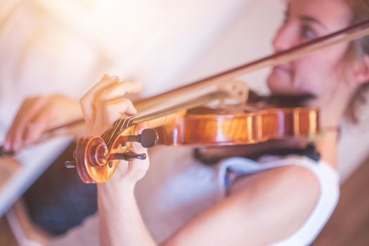 Pretty young girl practices on her violin, acoustic music