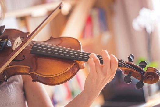 Young girl practices on her violin, acoustic music