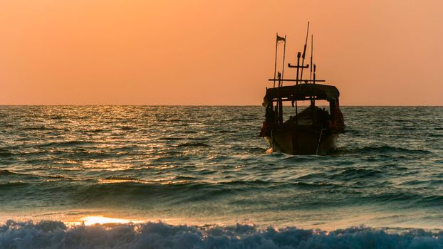 a silhouette boat on the ocean, coastline at sunrise, bule and orange colors