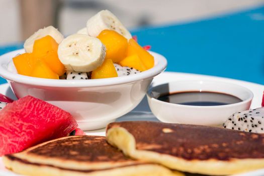 A fruit salad with panckes breakfast