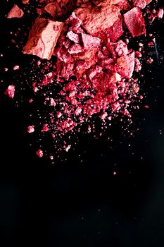 Crushed cosmetics, mineral organic eyeshadow, blush and cosmetic powder isolated on black background, makeup and beauty banner, flatlay design.