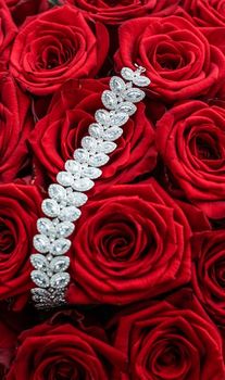 Gemstone jewellery, wedding fashion and luxe shopping concept - Luxury diamond bracelet and bouquet of red roses, jewelry love gift on Valentines Day and romantic holidays present