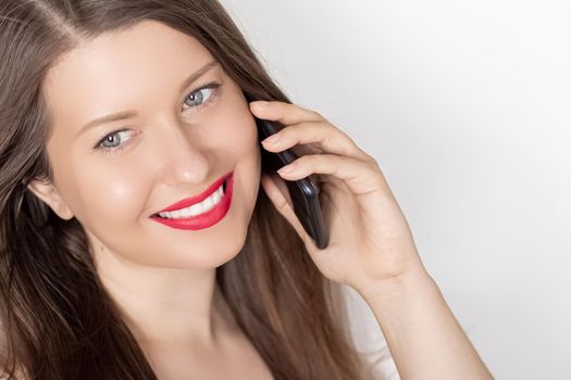 Happy smiling woman calling on smartphone, portrait on white background. People, technology and communication concept.