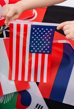 Child hand holding an American national flag in hand