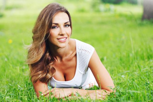 Portrait of attractive woman smiling in spring park nature background