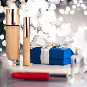 Cosmetic branding, Christmas glitter and girly blog concept - Holiday make-up foundation base, concealer and blue gift box, luxury cosmetics present and blank label products for beauty brand design