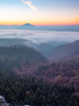 Orange mist above pure nature landscape. Romantic morning in hilly landscape