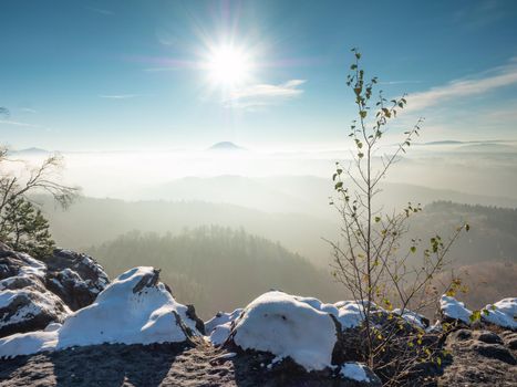 Snowy peak early morning.  Chill awaking in misty country. Morning sun hidden bellow  horizon