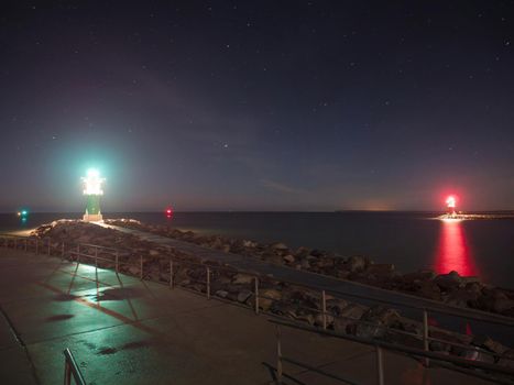 Bright light of Green and white breakwater lights at harbor entrance in Rostock Warnemunde, Germany 