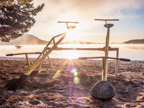 Swing or teeterboard on playground outdoors. Childhood, equipment and object concept