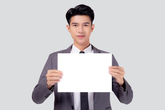 Young asian business man showing empty signboard for advertising isolated on white background, businessman confident holding billboard banner for presenting with copy space, success and achievement.