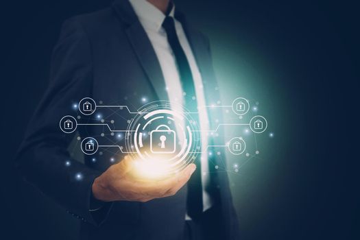 Hand of businessman holding virtual lock icon while cyber security, access data and privacy with protection digital, innovation of system protect for identity, business futuristic concept.