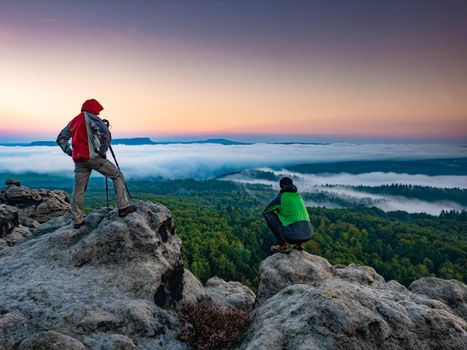 Photographer prepared to take pictures in the mountains. Fall autumn forest nature landscape. Active man enjoying hike and healthy outdoor active lifestyle.
