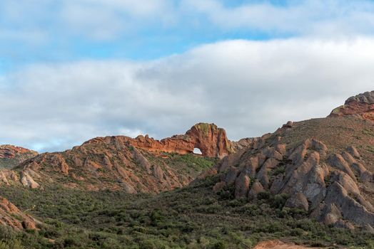 Vensterkop, a hole in the mountain at Red Stone Hills in the Western Cape Karoo. A second hole is visible to the far left