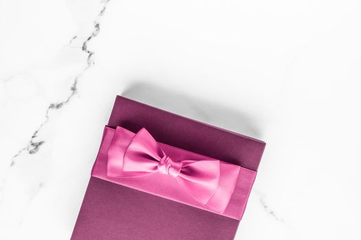 Birthday, wedding and girly branding concept - Pink gift box with silk bow on marble background, girl baby shower present and glamour fashion gift for luxury beauty brand, holiday flatlay art design