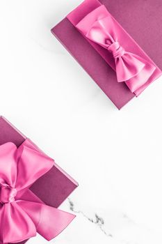 Birthday, wedding and girly branding concept - Pink gift box with silk bow on marble background, girl baby shower present and glamour fashion gift for luxury beauty brand, holiday flatlay art design