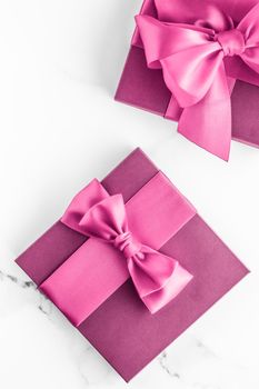 Birthday, wedding and girly branding concept - Pink gift box with silk bow on marble background, girl baby shower present and glamour fashion gift for luxury beauty brand, holiday flatlay art design