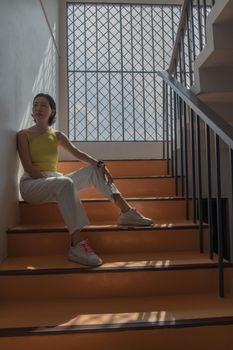Young asian woman and short hair posing for take a photo on stairs. Selective focus.