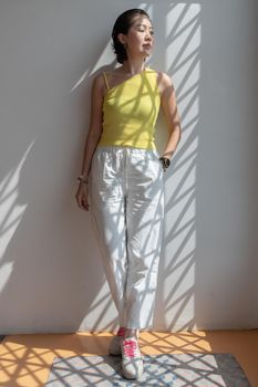 Young asian woman and short hair posing for take a photo on white wall. Selective focus.