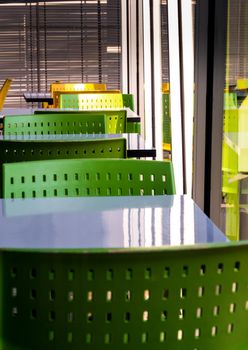 Empty white tables and green color plastic chairs that nobody sit in the cafeteria