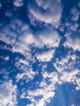 White fluffy clouds in the blue sky with morning light from the sunrise