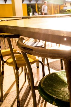 Rusty and old tables and chairs that nobody sit in the cafeteria