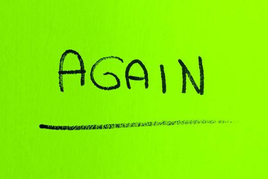 AGAIN word made with spray paint on green background