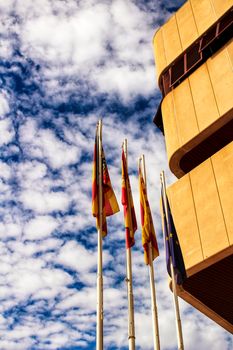 Constitutional flags of Spain and Europe at the city hall in a cloudy day in Santa Pola, Alicante, Spain