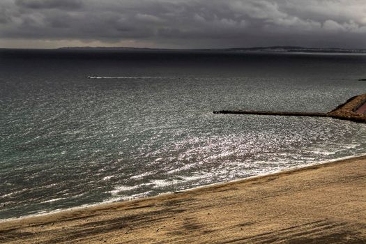 Beach under stormy sky in Santa Pola, Alicante, Spain