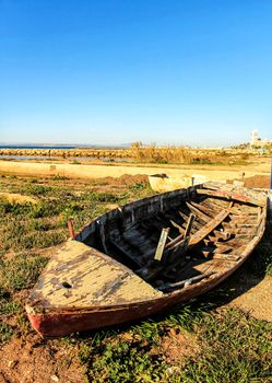 Old abandoned wooden boat on the beach in Santa Pola, Alicante, Spain