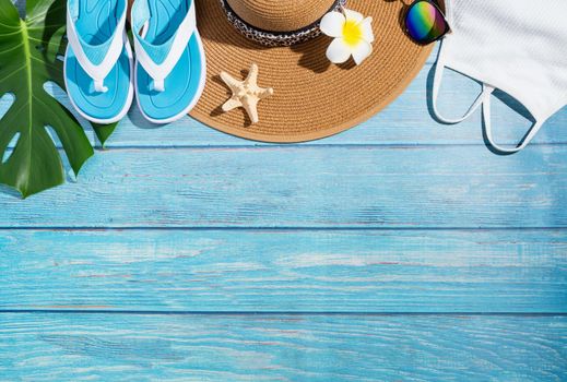 Summer and vacation concept. summer accessories with clothes, shoes, tropical leaves and flowers, flat lay