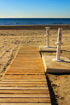 Footbath shower and walkway to the beach in the morning in a cloudy day