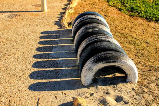 Ecological bicycle parking made with tires on the beach in Santa Pola, Spain