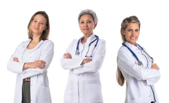 Team of three smiling female medical doctors with stethoscopes in white uniform isolated on white background