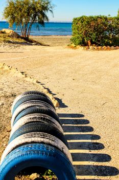 Ecological bicycle parking made with tires on the beach in Santa Pola, Spain