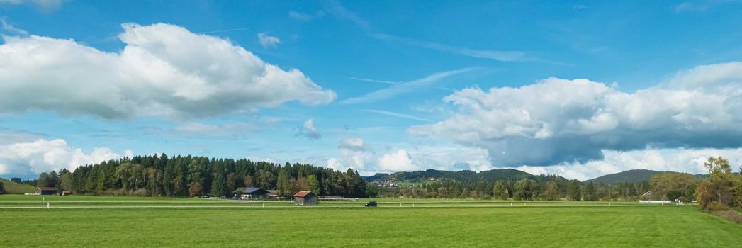 Beautiful nature of European Alps, landscape view of alpine mountains, lake and village on a sunny day, travel and destination scenery