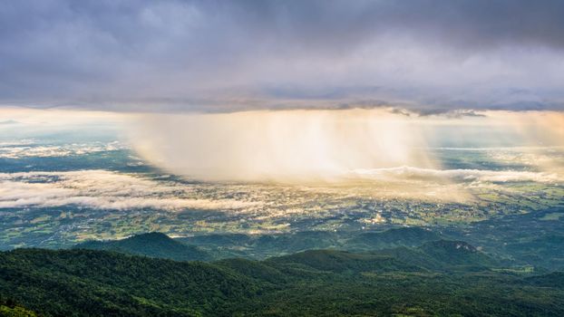 High view beautiful nature landscape of the mountain sky forest and the rain is falling sunlight shining through is golden at Phu Thap Berk viewpoint, Phetchabun, Thailand, 16:9 wide screen