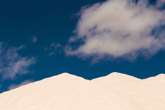 Salt mountains under blue sky in Santa Pola, Spain