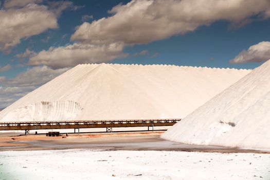 Salt mountains under blue sky in Santa Pola, Spain