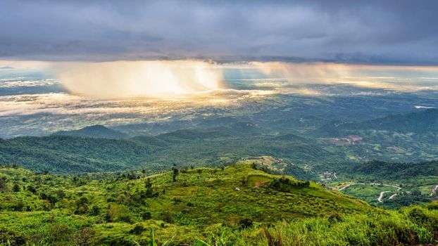 High view beautiful nature landscape of the mountain sky forest and the rain is falling sunlight shining through is golden at Phu Thap Berk viewpoint, Phetchabun, Thailand, 16:9 wide screen