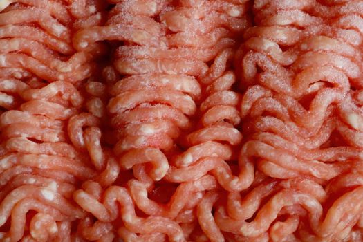 Close-up on red frozen minced meat for cooking. Background