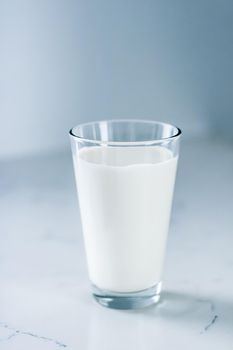 Dairy, healthy nutrition and breakfast concept - World Milk Day, full glass on marble table