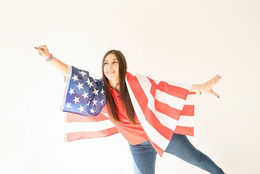 Independence day of the USA. Happy July 4th. beautiful young woman with american flag on white background