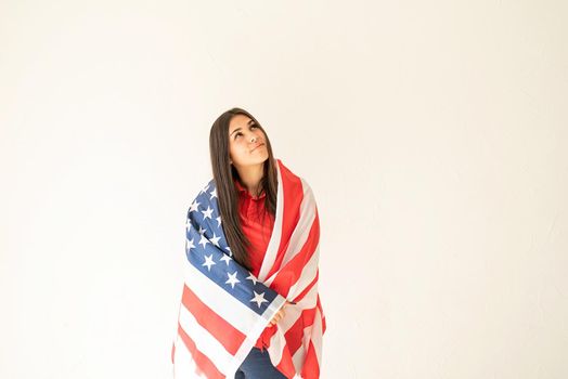 Independence day of the USA. Happy July 4th. beautiful young woman with american flag on white background